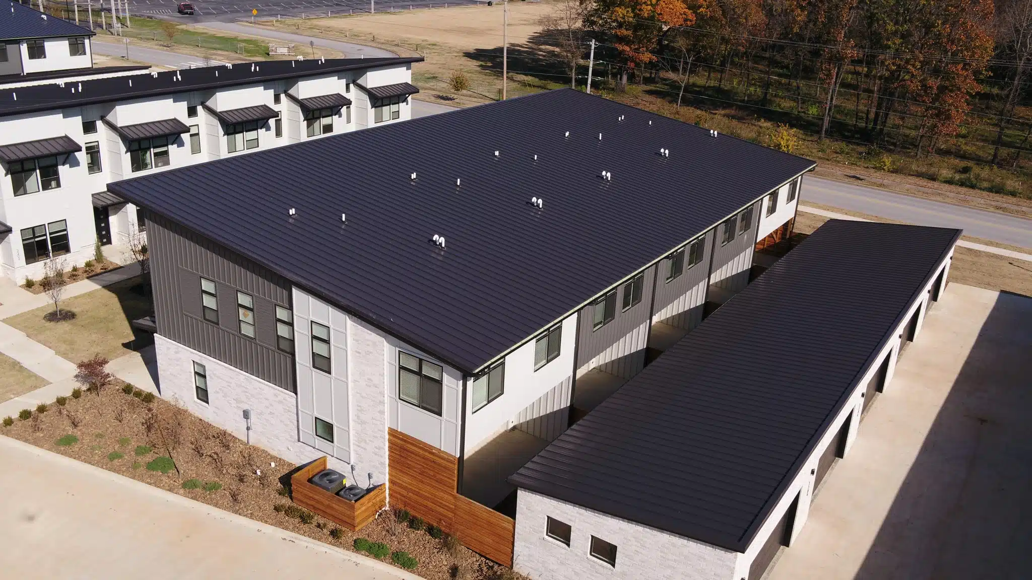 Townhouses with a Central Snap metal roof in dark bronze