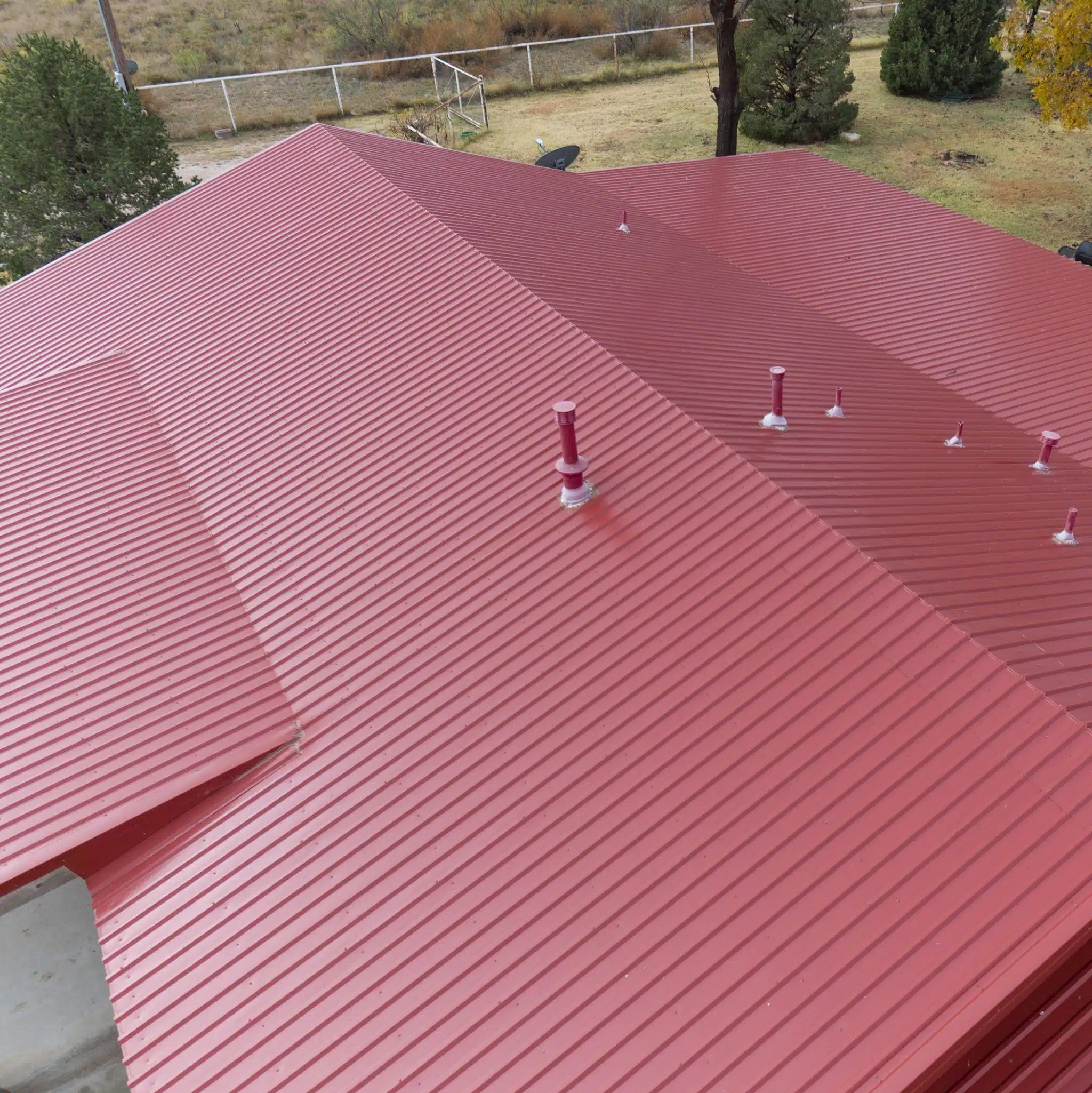 House with red M-Loc Metal Roof
