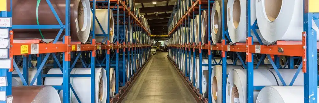 metal coils on storage racks in warehouse