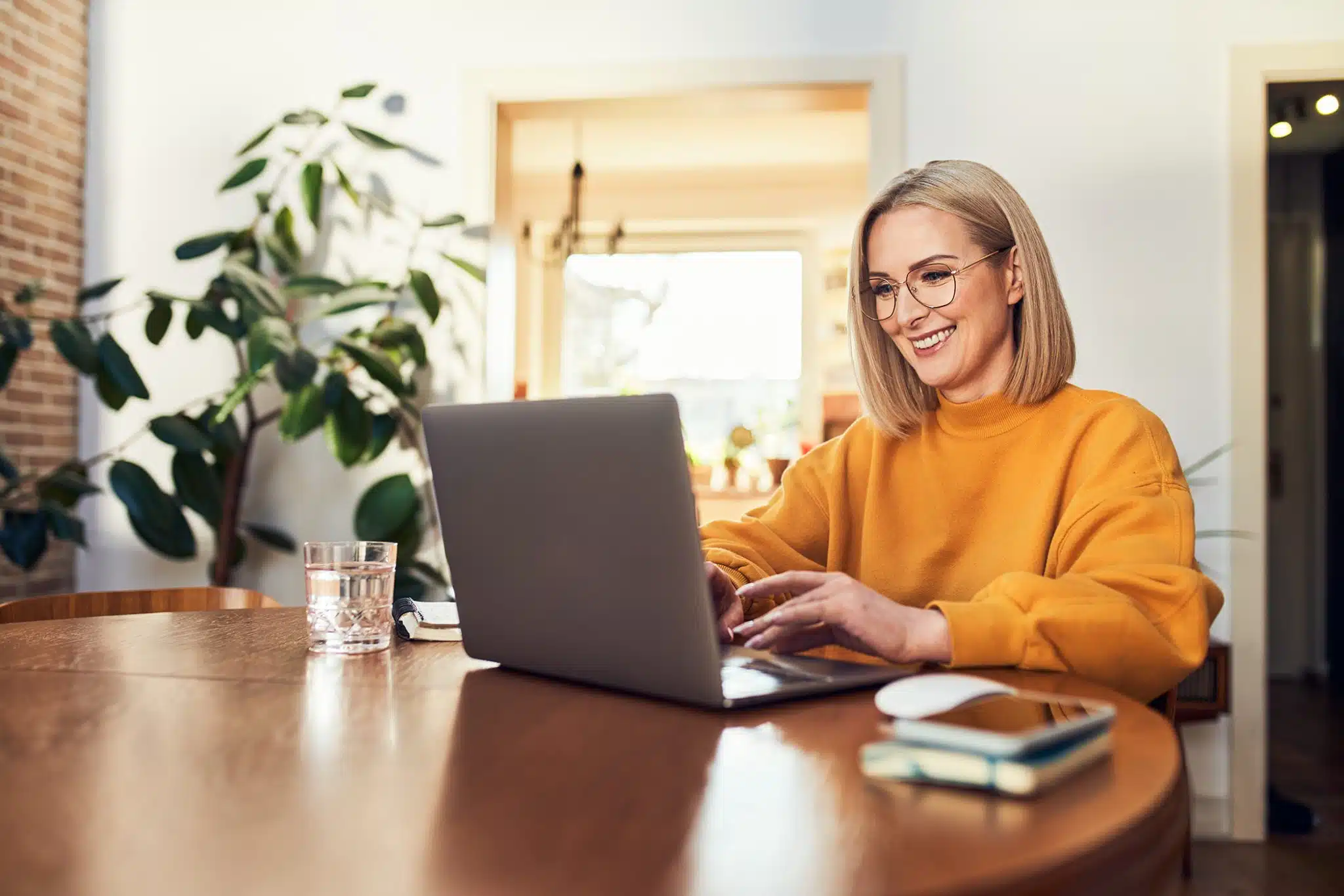 Woman at Laptop smiling and working