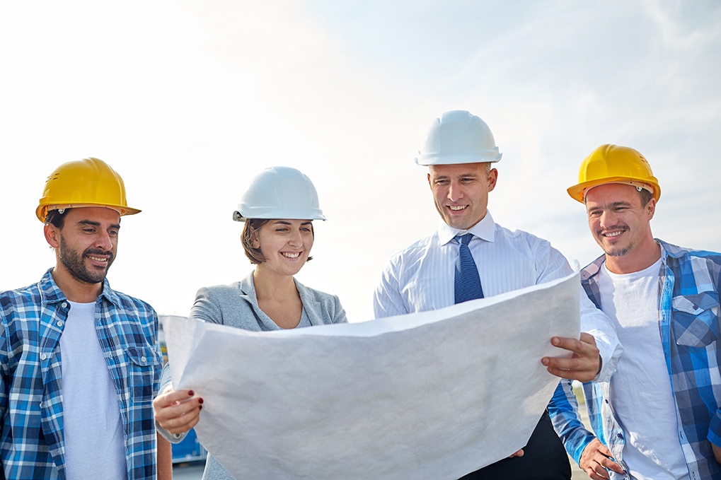 group of builders and architects with blueprint
