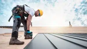 Employee installing a metal roof