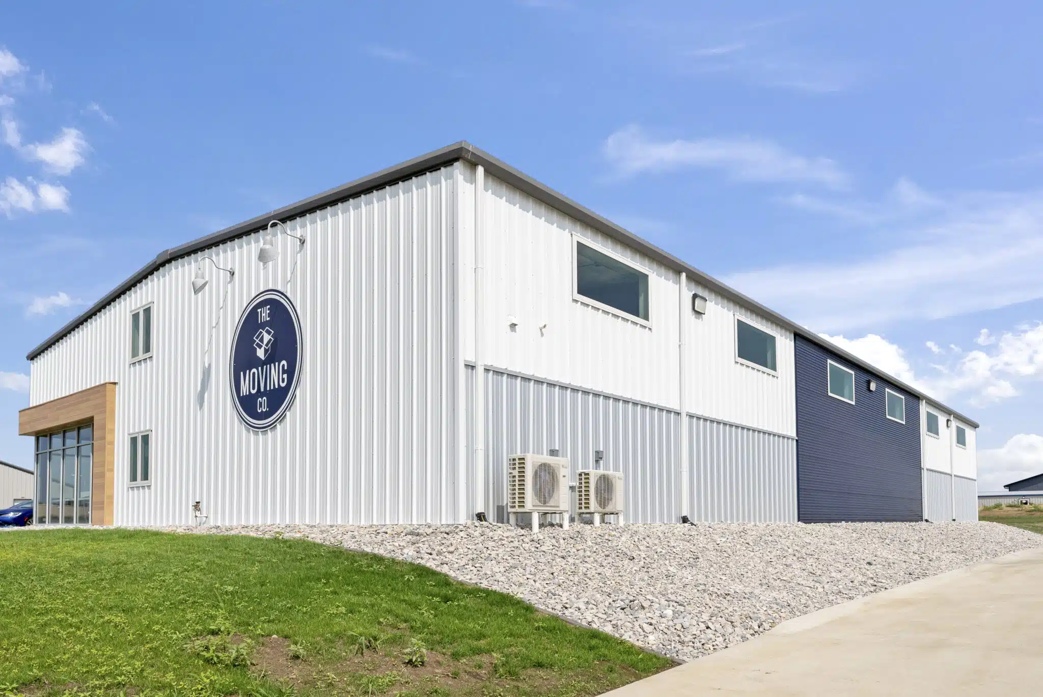Storage building with metal roof and walls and moving company sign on building